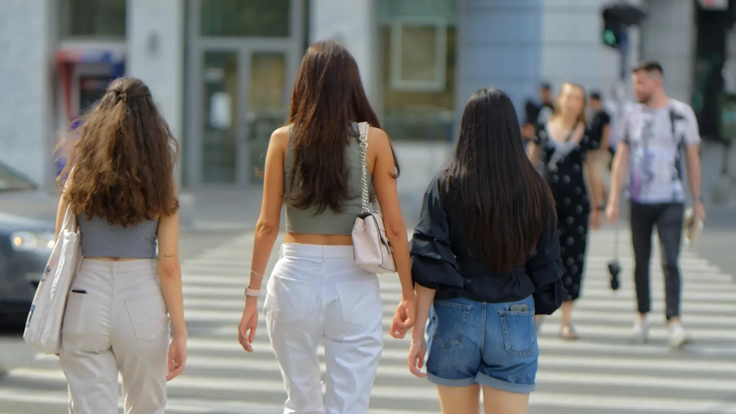 Young people crossing a city street at a crosswalk